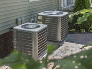 Two HVAC residential units outside a home.