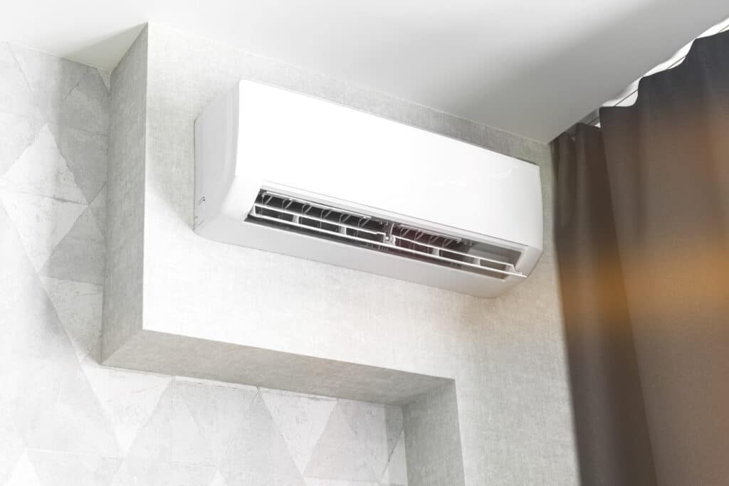 Ductless mini-split air handler mounted on a gray wall
